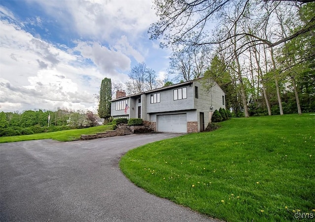 6010 E Lake Rd, Sullivan, NY 13035 - bi-level home featuring asphalt driveway, a chimney, a front lawn, and an attached garage