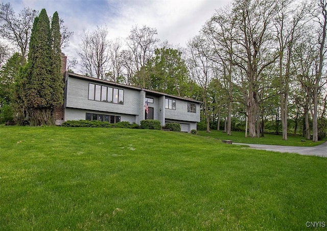 6010 E Lake Rd, Sullivan, NY 13035 - bi-level home featuring a chimney, a front lawn, and a garage