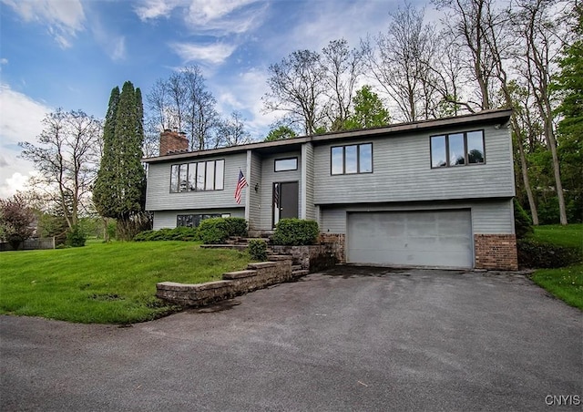 6010 E Lake Rd, Sullivan, NY 13035 - raised ranch with an attached garage, asphalt driveway, a chimney, a front yard, and brick siding
