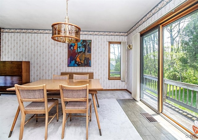 6010 E Lake Rd, Sullivan, NY 13035 - dining space featuring wallpapered walls, a chandelier, and baseboards