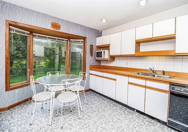 6010 E Lake Rd, Sullivan, NY 13035 - kitchen with a sink, black dishwasher, white microwave, open shelves, and wallpapered walls