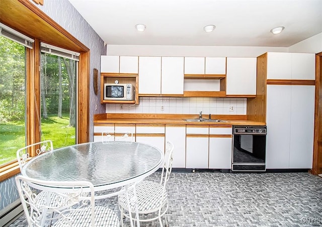 6010 E Lake Rd, Sullivan, NY 13035 - kitchen with dishwasher, a sink, white cabinets, decorative backsplash, and open shelves