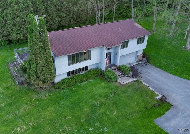 6010 E Lake Rd, Sullivan, NY 13035 - view of front of home featuring asphalt driveway, a garage, a view of trees, and a front lawn