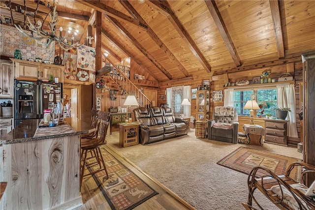 8311 State Route 415, Campbell, NY 14821 - living room with wood walls, high vaulted ceiling, wood ceiling with exposed beams, stairs, and wood finished floors