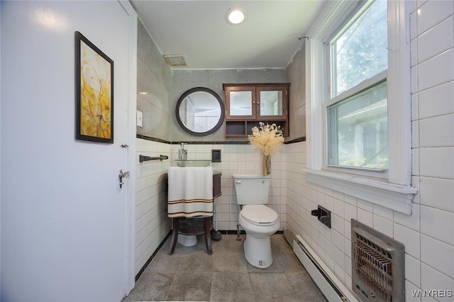 445 Connecticut St, Buffalo, NY 14213 - bathroom featuring toilet, a baseboard heating unit, tile patterned floors, tile walls, and a wall mounted AC