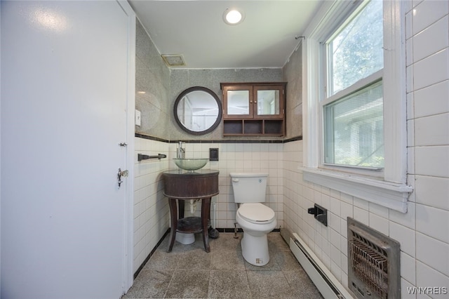 445 Connecticut St, Buffalo, NY 14213 - half bathroom featuring toilet, a baseboard radiator, tile walls, and an AC wall unit