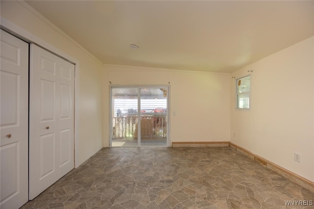 445 Connecticut St, Buffalo, NY 14213 - unfurnished bedroom featuring stone floors, multiple windows, ornamental molding, and a closet