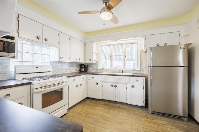 40 Mcnaughton St, Rochester, NY 14606 - kitchen with stainless steel appliances, dark countertops, and white cabinetry