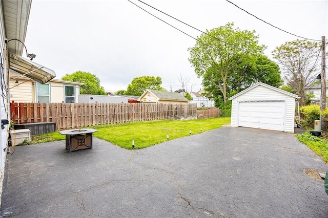 40 Mcnaughton St, Rochester, NY 14606 - view of patio with a garage, an outdoor structure, an outdoor fire pit, and driveway