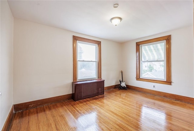 40 Mcnaughton St, Rochester, NY 14606 - unfurnished room with radiator, wood finished floors, healthy amount of natural light, and baseboards