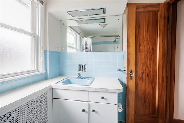 40 Mcnaughton St, Rochester, NY 14606 - full bathroom featuring vanity, curtained shower, tasteful backsplash, and tile walls