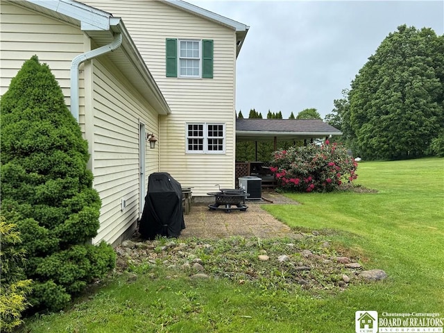 8900 Brownell Rd, Clymer, NY 14724 - rear view of property featuring central AC unit, a yard, and a patio