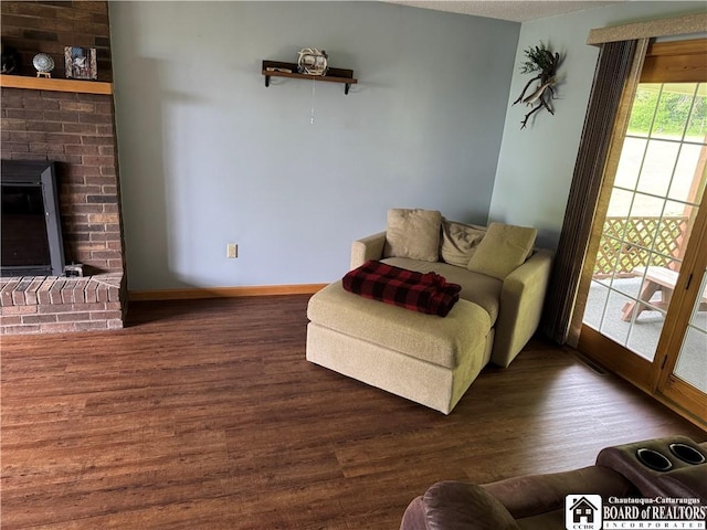 8900 Brownell Rd, Clymer, NY 14724 - living area featuring wood finished floors, baseboards, and a fireplace