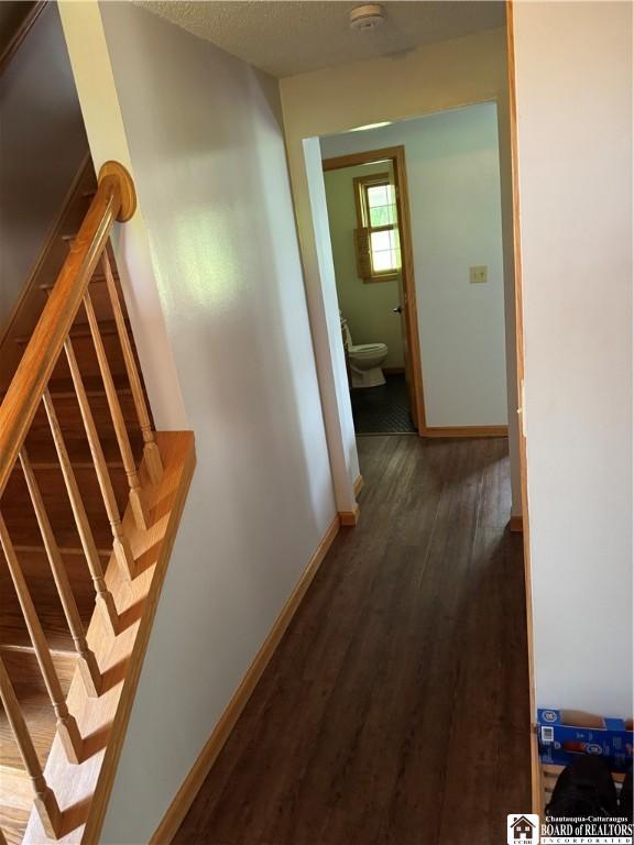 8900 Brownell Rd, Clymer, NY 14724 - hall featuring dark wood-style flooring, baseboards, and stairway