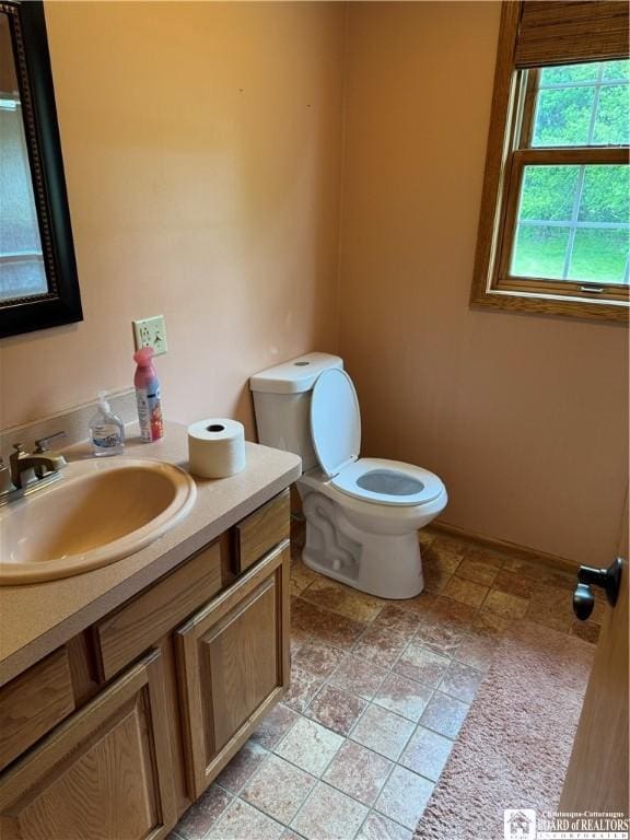 8900 Brownell Rd, Clymer, NY 14724 - half bath with toilet, vanity, and stone finish flooring