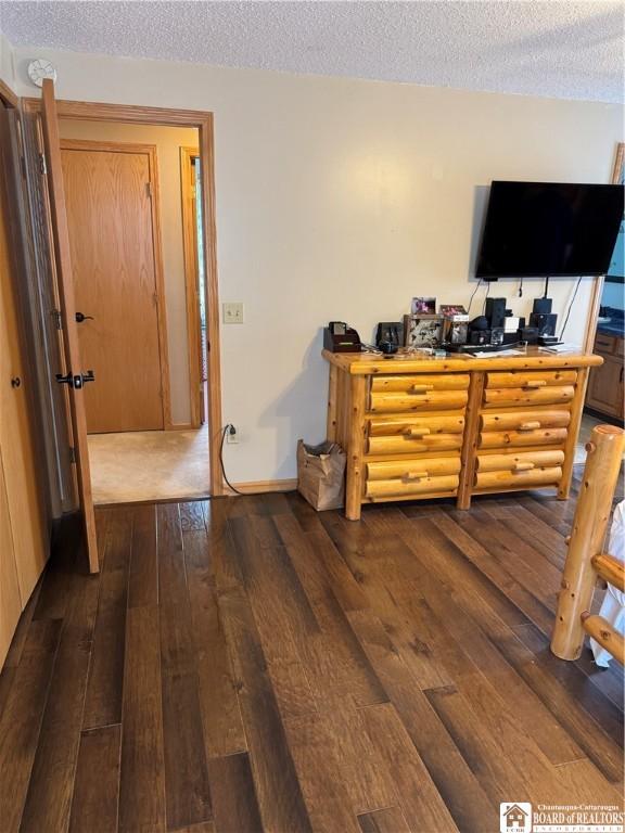 8900 Brownell Rd, Clymer, NY 14724 - bedroom with dark wood-type flooring and a textured ceiling