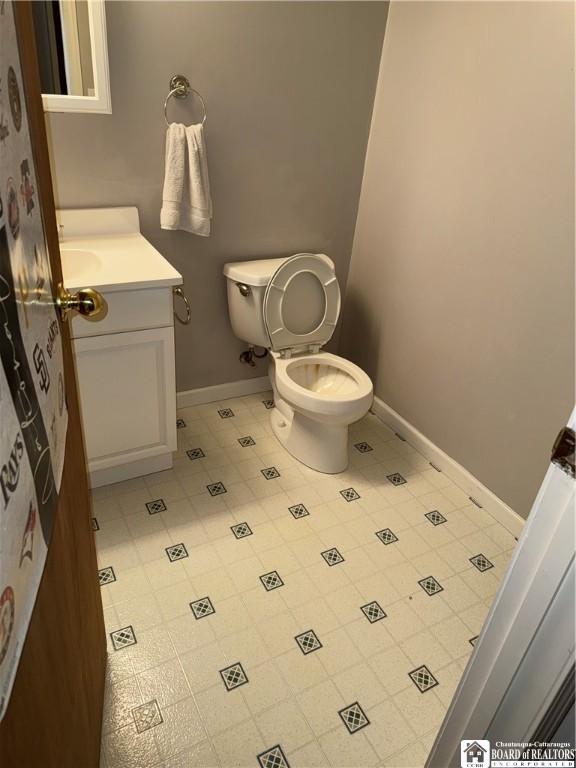 8900 Brownell Rd, Clymer, NY 14724 - bathroom with vanity, baseboards, toilet, and tile patterned floors