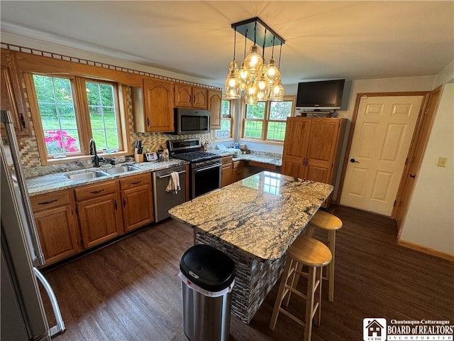 8900 Brownell Rd, Clymer, NY 14724 - kitchen with stainless steel appliances, a sink, dark wood finished floors, and brown cabinetry