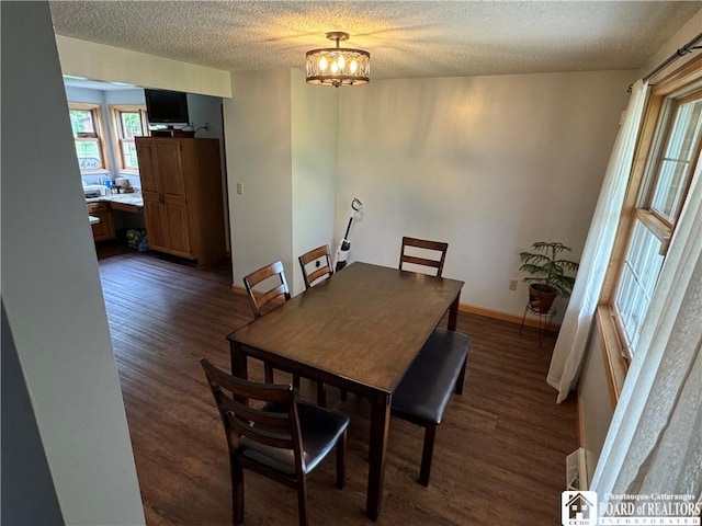 8900 Brownell Rd, Clymer, NY 14724 - dining room featuring a textured ceiling, dark wood-style floors, baseboards, and a chandelier