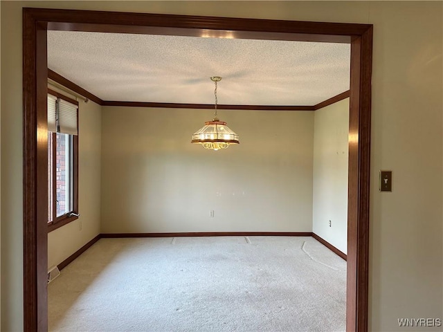 55 Hemlock Ln, Lancaster, NY 14086 - spare room featuring light carpet, crown molding, baseboards, a textured ceiling, and a chandelier