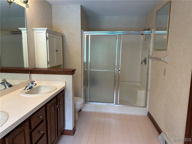 55 Hemlock Ln, Lancaster, NY 14086 - full bathroom with a shower stall, double vanity, toilet, tile patterned flooring, and a textured ceiling
