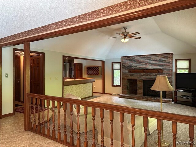 55 Hemlock Ln, Lancaster, NY 14086 - unfurnished living room featuring healthy amount of natural light, baseboards, a fireplace, and lofted ceiling