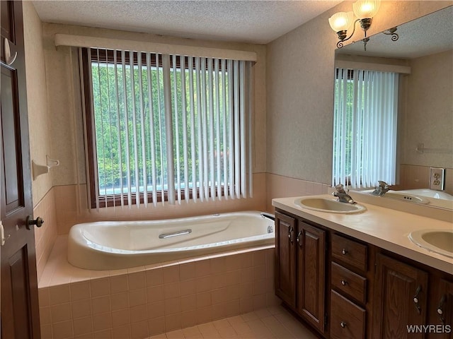 55 Hemlock Ln, Lancaster, NY 14086 - bathroom with plenty of natural light, a bath, double vanity, a textured ceiling, and tile patterned floors