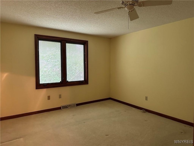 55 Hemlock Ln, Lancaster, NY 14086 - spare room featuring light carpet, a ceiling fan, a textured ceiling, and baseboards
