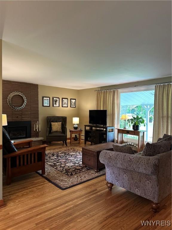 4710 Boncrest Dr E, Clarence, NY 14221 - living area featuring wood finished floors and a fireplace