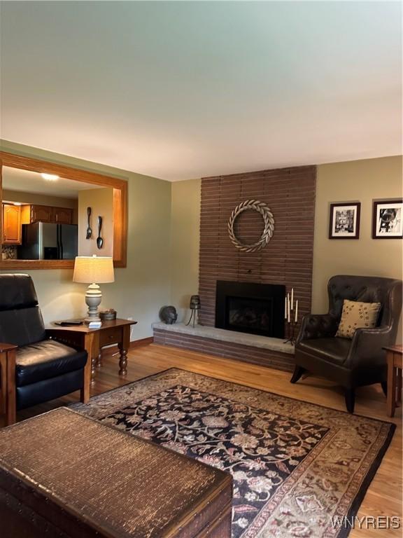 4710 Boncrest Dr E, Clarence, NY 14221 - living room with light wood-type flooring and a fireplace