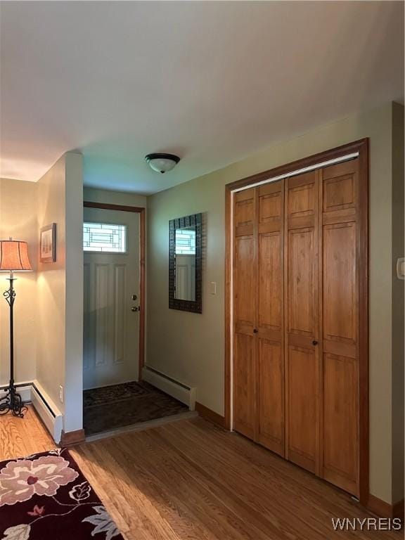 4710 Boncrest Dr E, Clarence, NY 14221 - foyer entrance with a baseboard heating unit, light wood-type flooring, and baseboards