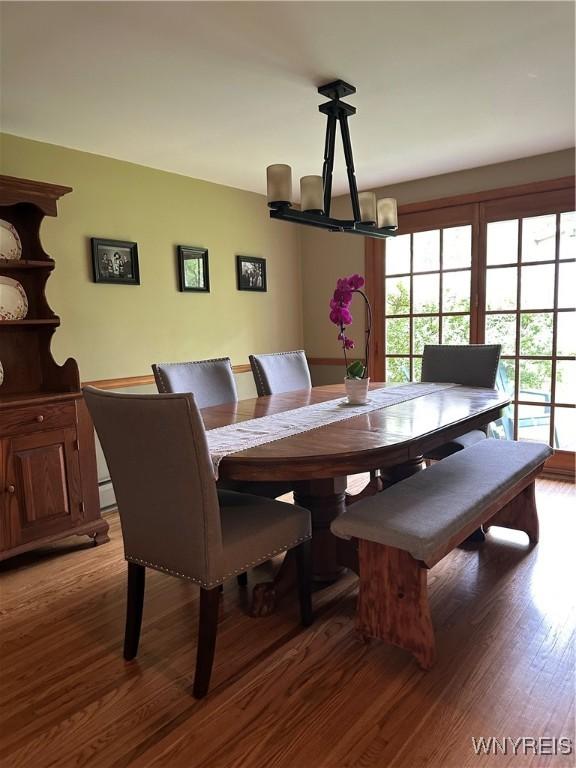 4710 Boncrest Dr E, Clarence, NY 14221 - dining room with a chandelier and light wood-type flooring