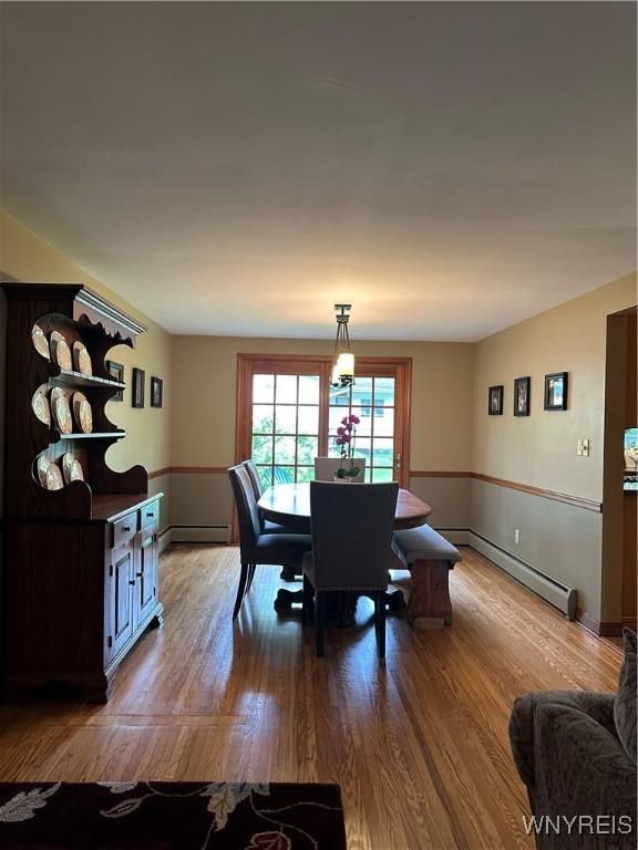 4710 Boncrest Dr E, Clarence, NY 14221 - dining space with baseboard heating, wood finished floors, and baseboards