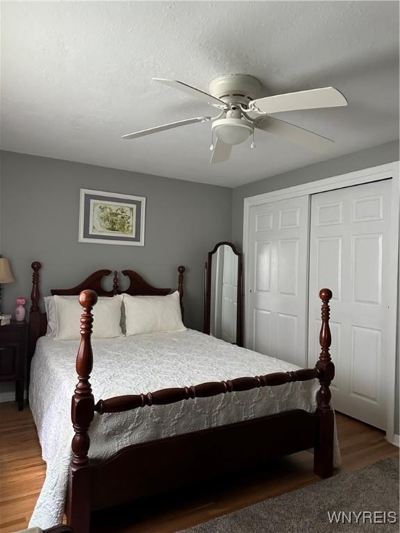 4710 Boncrest Dr E, Clarence, NY 14221 - bedroom with a closet, a ceiling fan, and wood finished floors