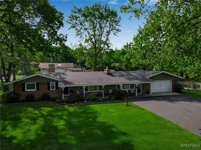 4710 Boncrest Dr E, Clarence, NY 14221 - single story home with asphalt driveway, a chimney, and a garage