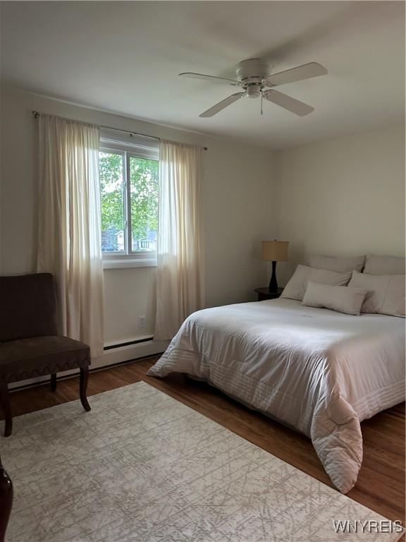 4710 Boncrest Dr E, Clarence, NY 14221 - bedroom featuring wood finished floors, ceiling fan, and a baseboard radiator