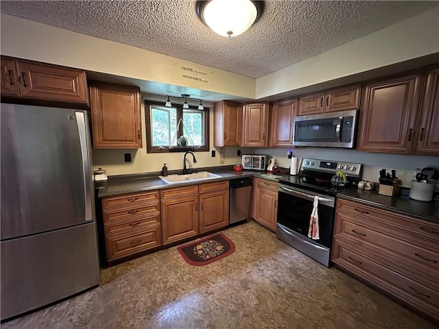 390 Bolivar Dr, Foster-Town, PA 16701 - kitchen with appliances with stainless steel finishes, a sink, dark countertops, a textured ceiling, and brown cabinetry