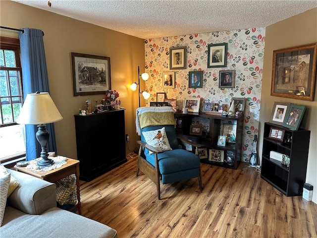 390 Bolivar Dr, Foster-Town, PA 16701 - living area with a textured ceiling, wood finished floors, and wallpapered walls