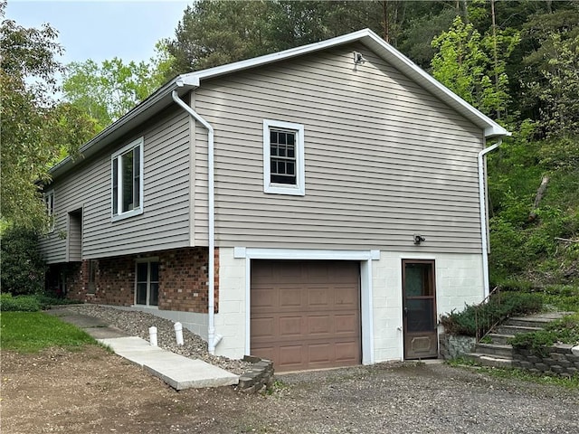 390 Bolivar Dr, Foster-Town, PA 16701 - view of home's exterior featuring a garage and driveway