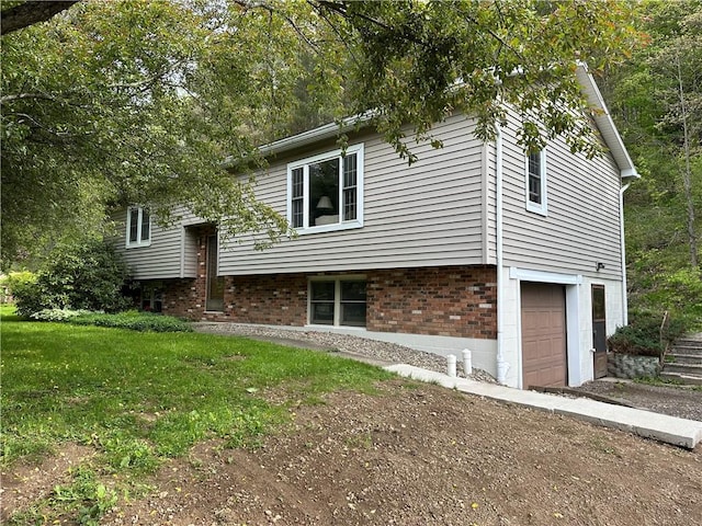 390 Bolivar Dr, Foster-Town, PA 16701 - view of front facade with a garage, a front yard, and brick siding