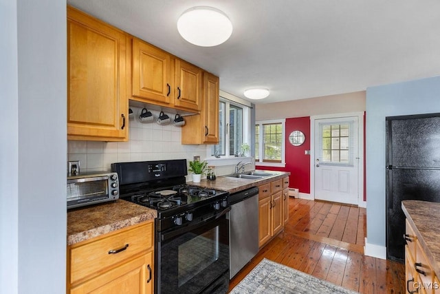 7649 Tuttle Rd, Cicero, NY 13030 - kitchen featuring black appliances, a sink, hardwood / wood-style flooring, baseboards, and backsplash