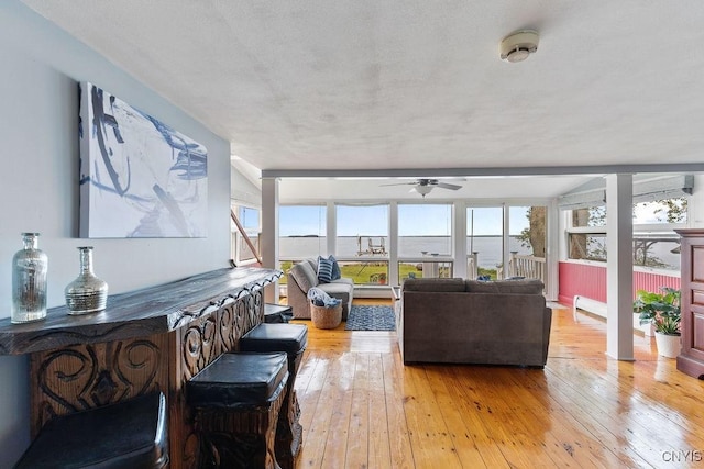 7649 Tuttle Rd, Cicero, NY 13030 - living room with light wood-style floors and a ceiling fan