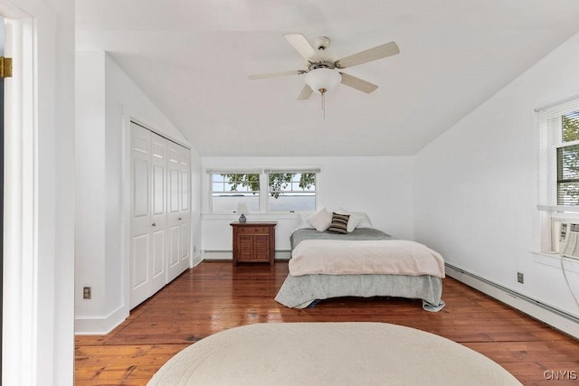7649 Tuttle Rd, Cicero, NY 13030 - bedroom featuring lofted ceiling, a baseboard heating unit, hardwood / wood-style flooring, baseboard heating, and a closet