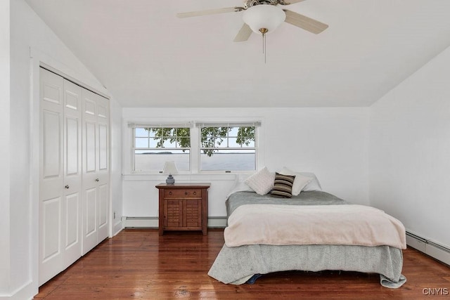 7649 Tuttle Rd, Cicero, NY 13030 - bedroom with lofted ceiling, a baseboard radiator, wood finished floors, a closet, and a ceiling fan