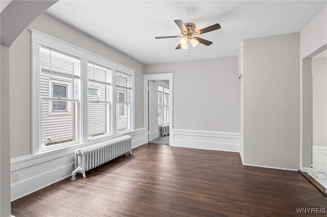 143 Lovering Ave, Buffalo, NY 14216 - empty room with radiator heating unit, a ceiling fan, and wood finished floors