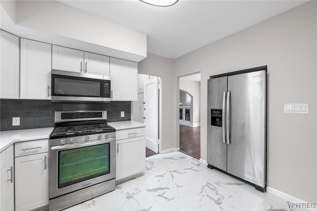 143 Lovering Ave, Buffalo, NY 14216 - kitchen featuring appliances with stainless steel finishes, light marble finish floors, light countertops, and baseboards
