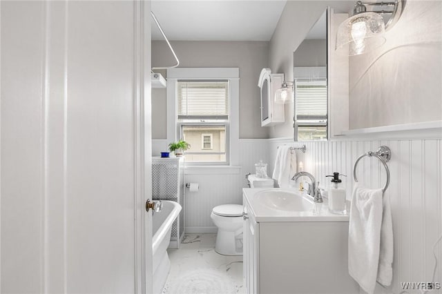143 Lovering Ave, Buffalo, NY 14216 - full bath with healthy amount of natural light, marble finish flooring, wainscoting, a bathtub, and toilet