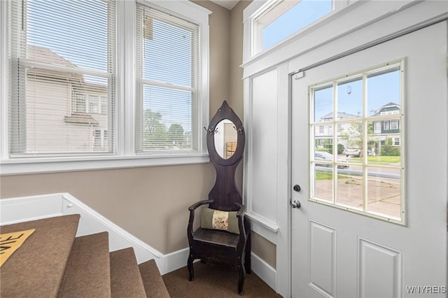 143 Lovering Ave, Buffalo, NY 14216 - foyer entrance with baseboards, carpet flooring, and stairs