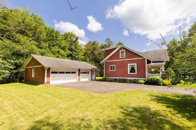 1031 Main St, Middletown, NY 12455 - view of property exterior featuring a garage, an outbuilding, and a lawn