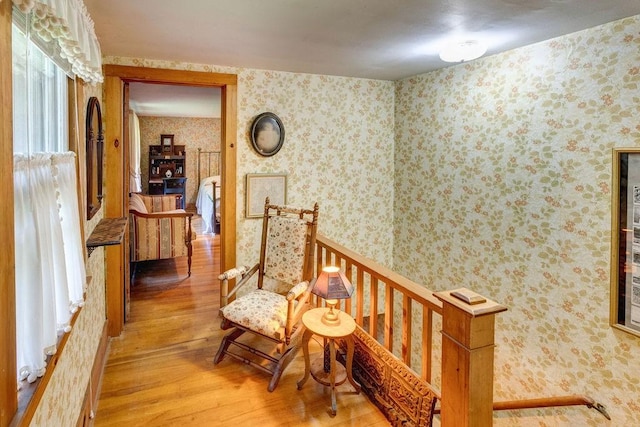 1031 Main St, Middletown, NY 12455 - hall with light wood-type flooring, wallpapered walls, and an upstairs landing